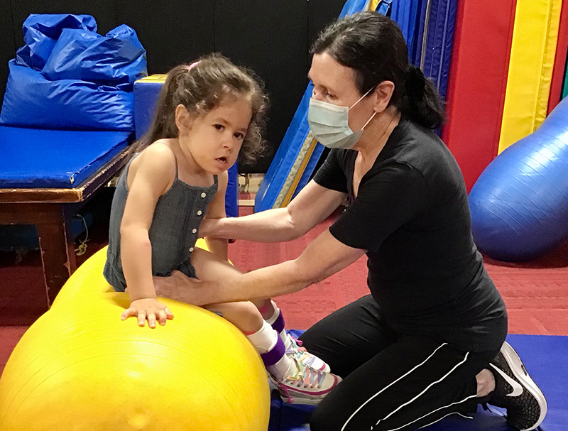 Physical therapy activity with teacher and child