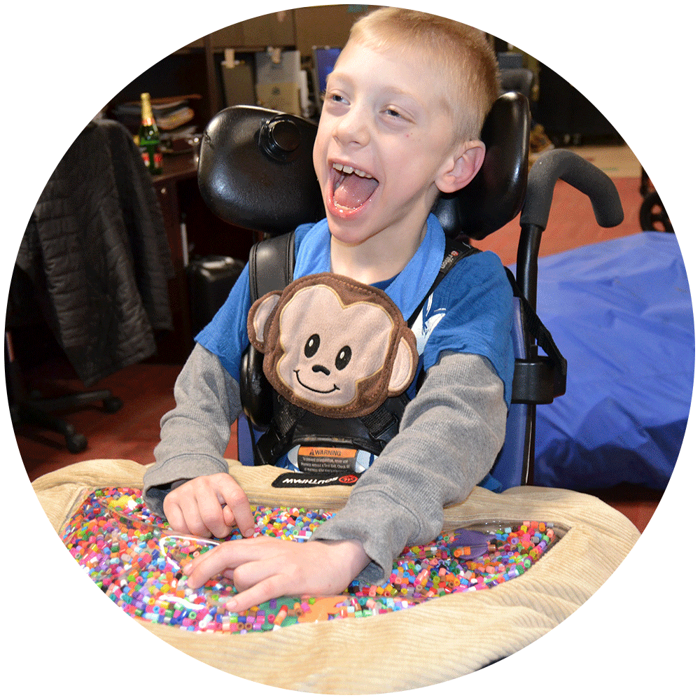 Boy in a wheel chair enjoying a sensory activity
