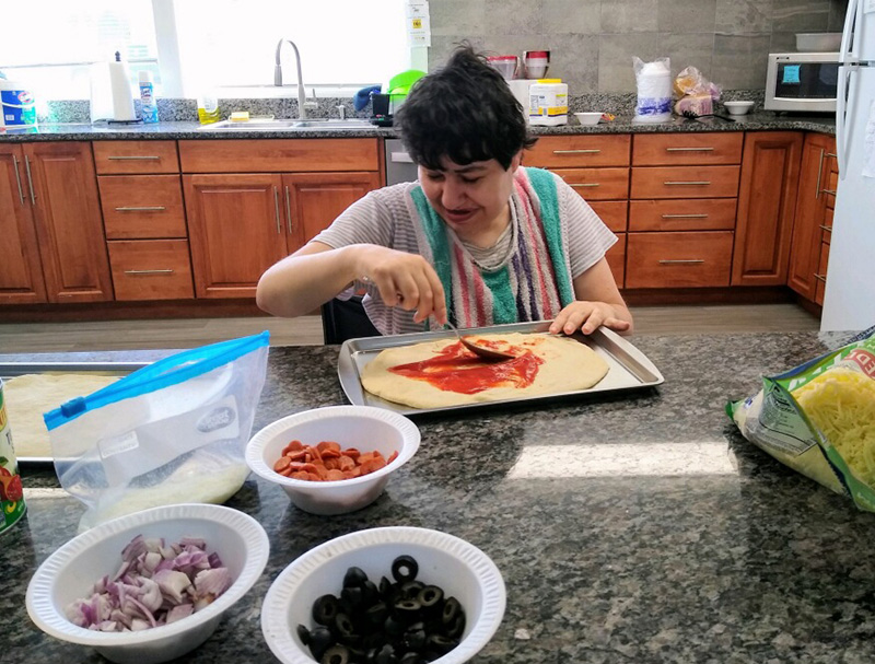 Woman making pizza in a residential home