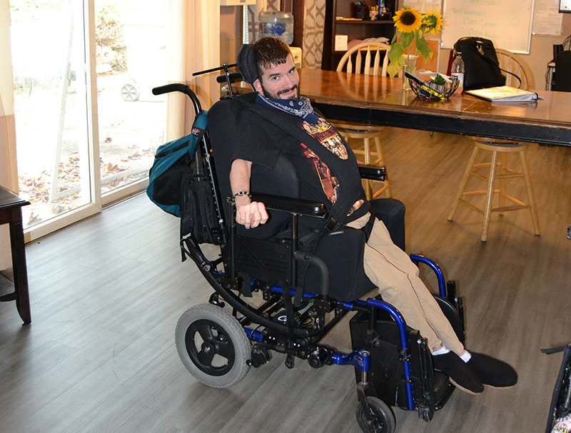 Man in a wheel chair within residential housing