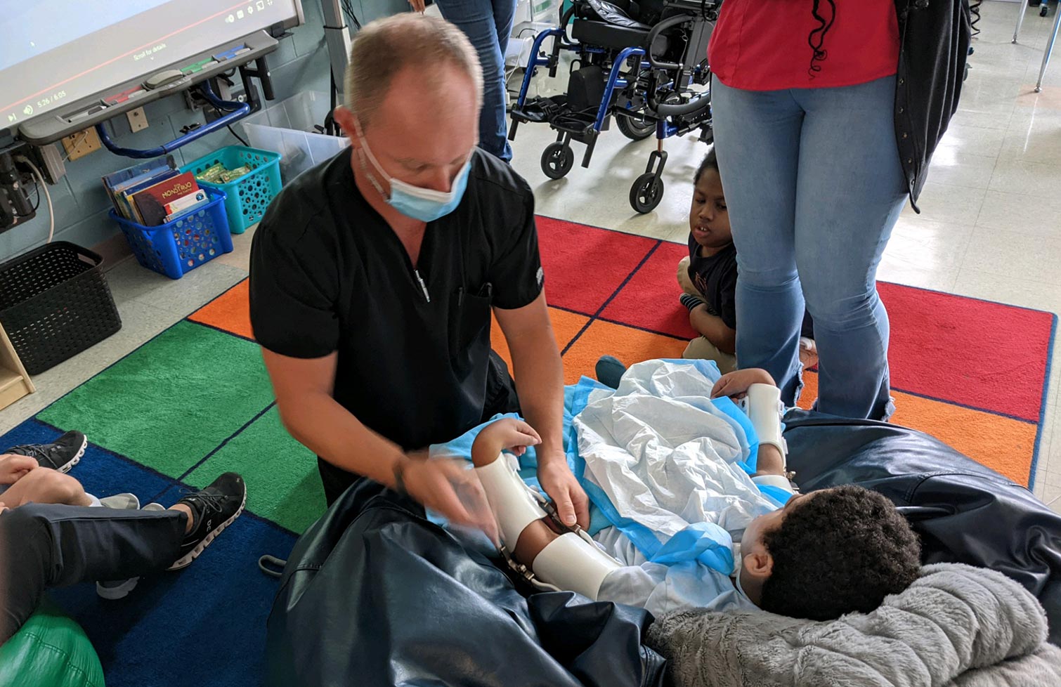 Clinician attending to a boy needing services