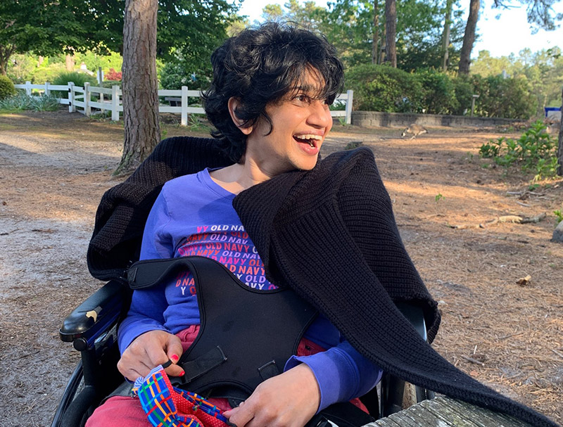 Smiling woman in wheel chair outdoors