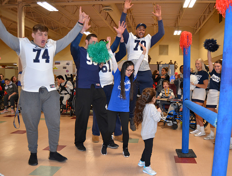 Volunteers cheering during an indoor activity day