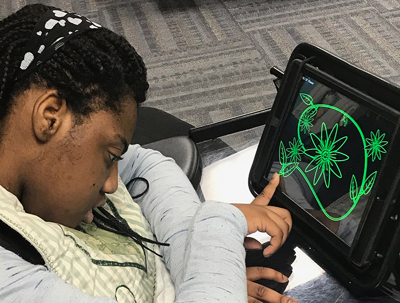 Girl using assistive technology to make digital art