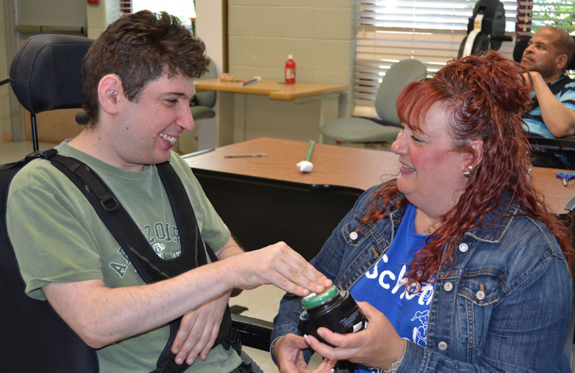 Student in wheel chair working with speech therapist